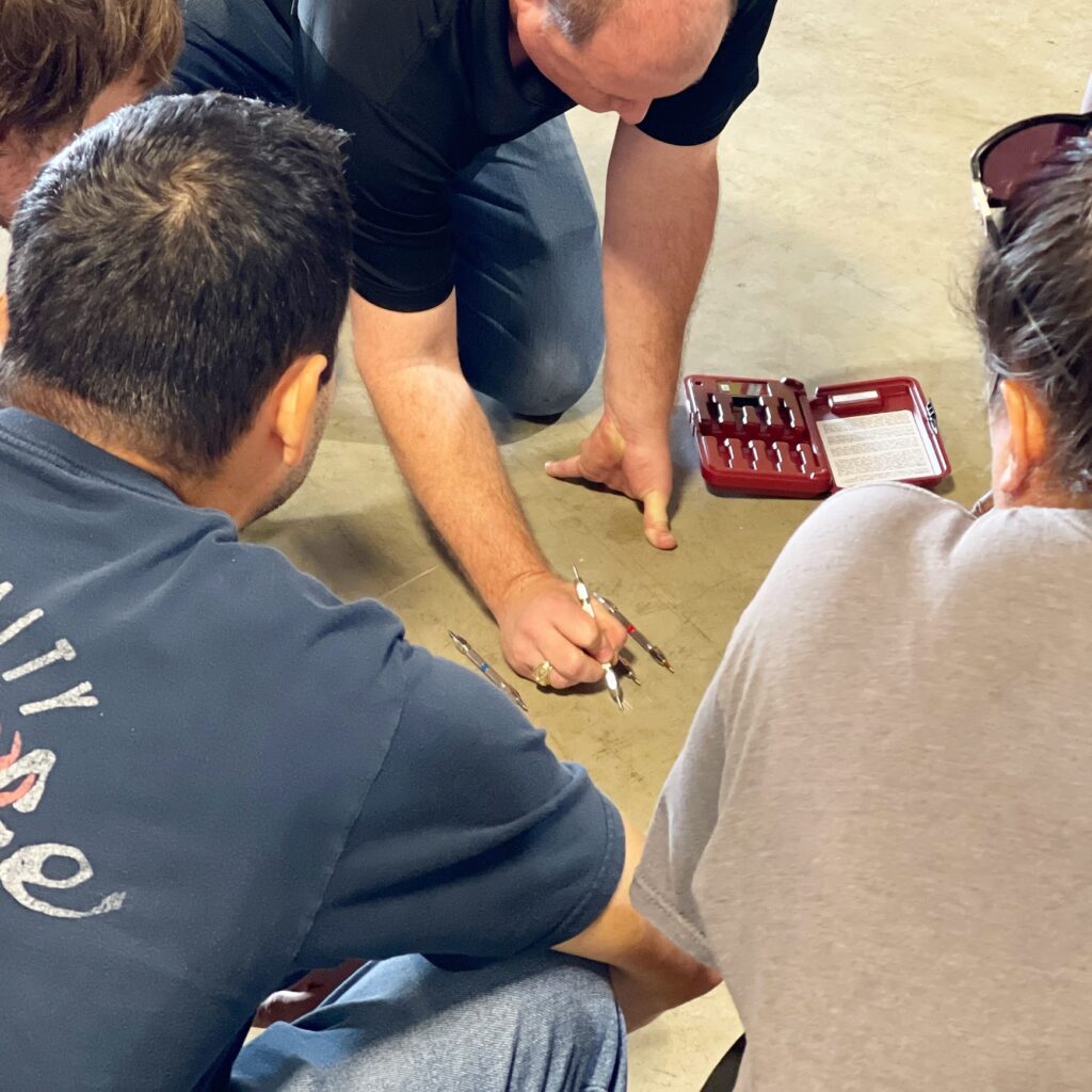A group of people sitting on the ground.