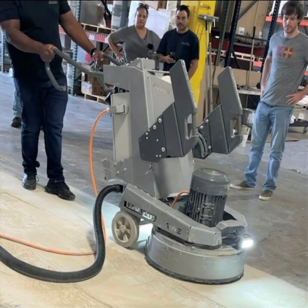 A group of people standing around a machine.