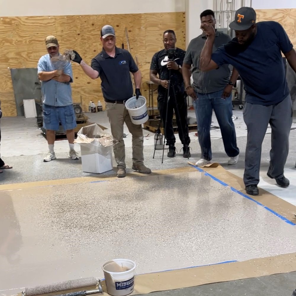 A group of men standing around in the middle of a room.