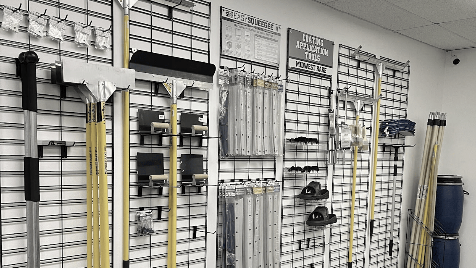 A wall of racks with many pairs of shoes on them.
