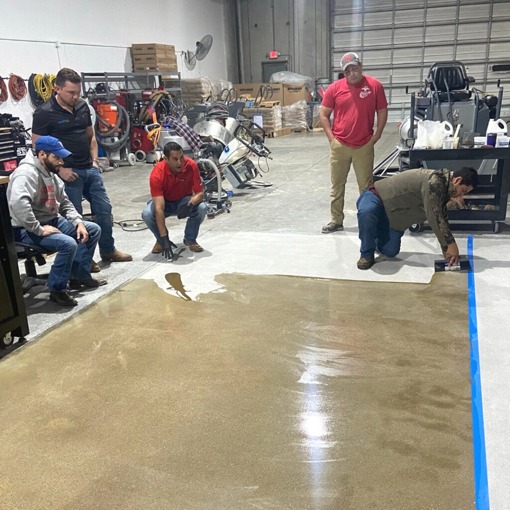 A group of people watching a man work on a skateboard ramp.
