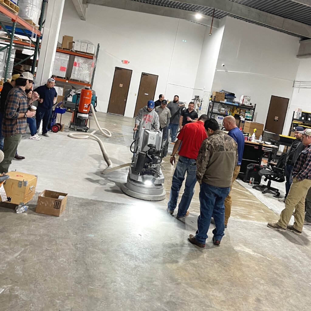 Team training on concrete floor grinder