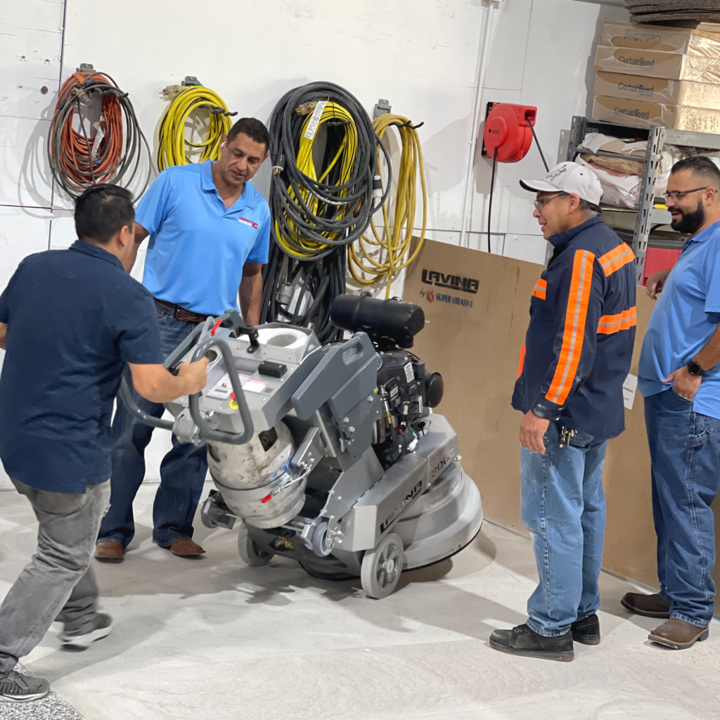 A group of men standing around a machine.