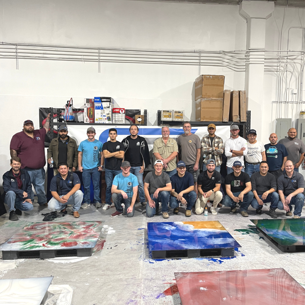 A group of people standing in front of some boxes.