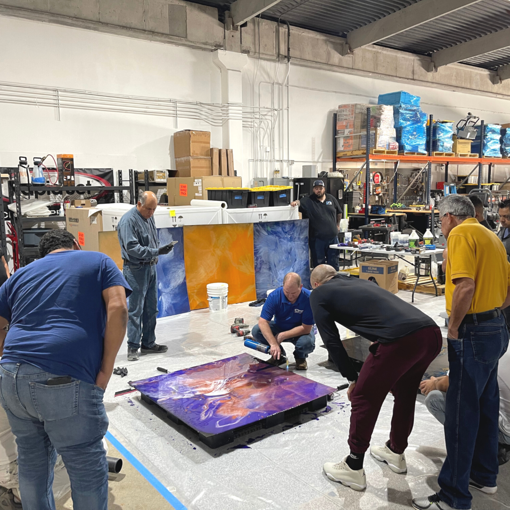 A group of people standing around in an art studio.