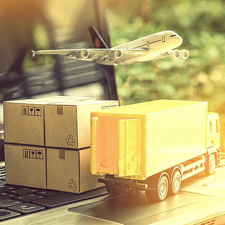 Miniature cargo truck and plane on laptop